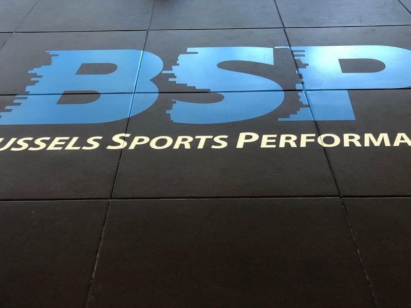 A cross-section diagram of rubber flooring showing its layers and density